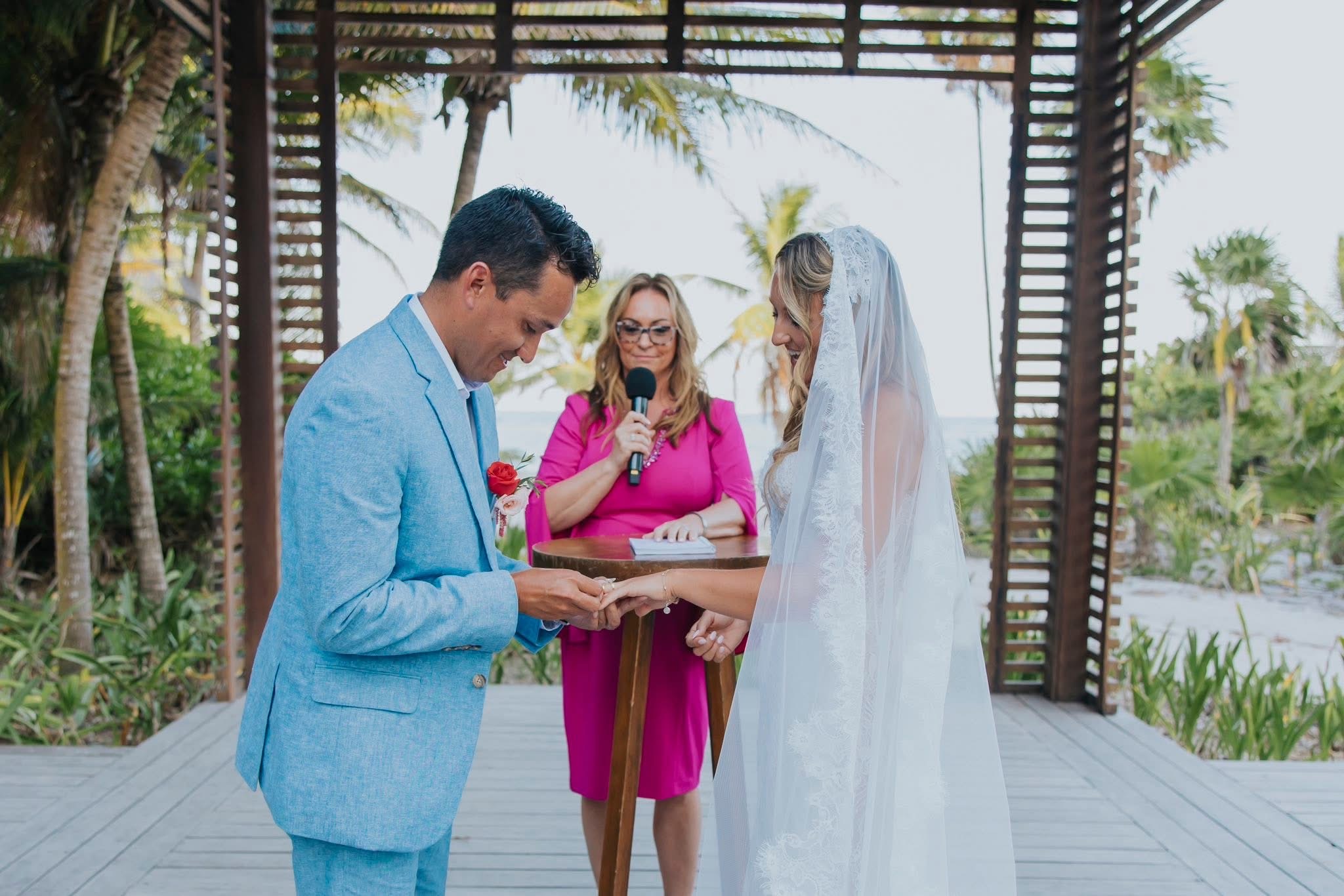 Amy officiating as the couple exchange rings at her niece’s wedding in Mexico